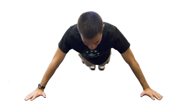 Hornet reporter William Miles demonstrates the starting position of a wide pushup.
