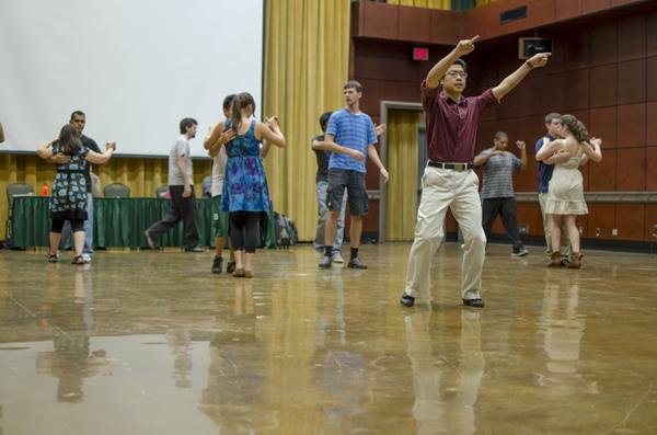 Guest instructor Scott Suwabe directs students in dancing the waltz. 
