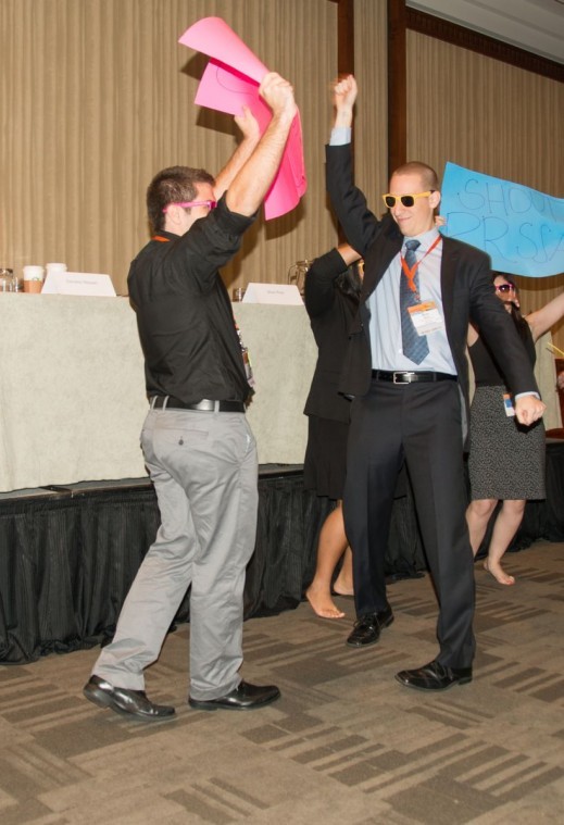 Students at the Public Relations Student Society of America national conference jump and celebrate.
