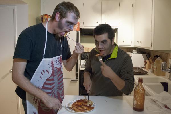 Zombified Hornet staffers Sean Keister and Miguel Lopez take a bite from saucy chicken breasts.
