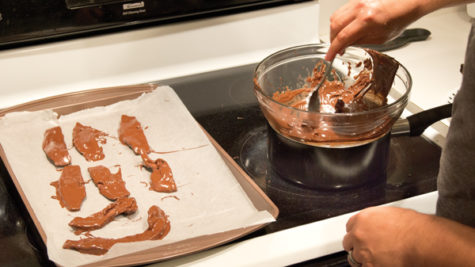 After you have dipped the bacon in chocolate - and have added sprinkles - place the strips on a baking sheet covered in wax paper and refrigerate them for 15 minutes or until the chocolate has hardened.