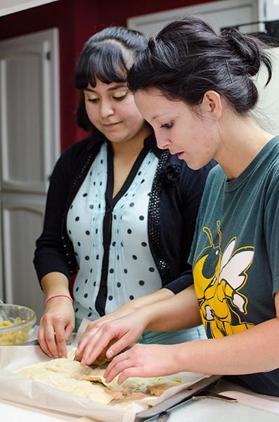 State Hornet reporters Jacquelin Everhart and Leticia Lopez prepare the dough for apple pie pop-tarts.
