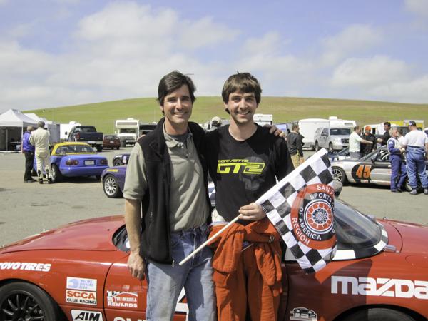 Phil Holifield holds the checkered flag with his father after winning at Thunderhill Raceway in September.
