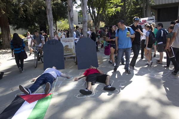 Students react to protesters playing dead.

