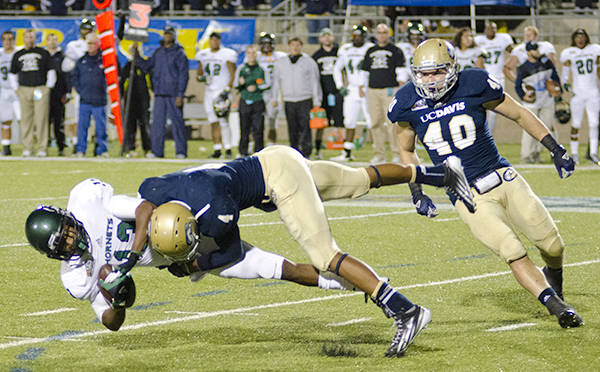 Hornets wide receiver Morris Norrise takes a huge hit from Aggies free safety Aarynn Jones.
