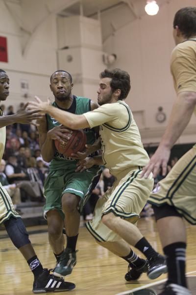 Sac State’s Julian Demalleville closely guards North Dakota’s Jamal Webb as he drives in the lane.
