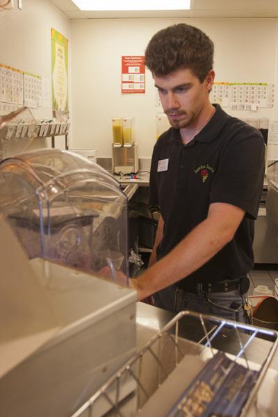 Justin Hamilton, general manager of the Jamba Juice located in the Union, makes a smoothie for a customer.
