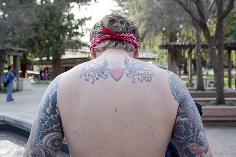 Mike Coats, junior marketing major, shows of some of many tattoos, each of which has it's own significance and is inspired by an event in his life.