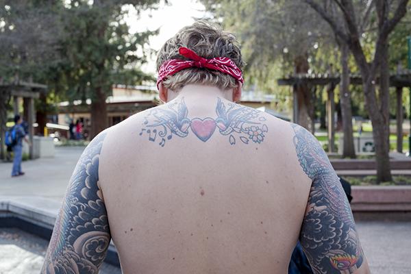 Mike Coats, junior marketing major, shows of some of many tattoos, each of which has its own significance and is inspired by an event in his life.
