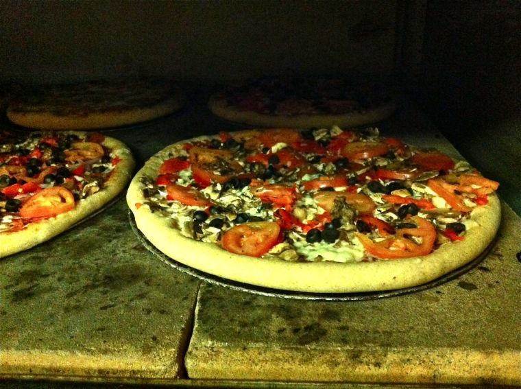 The Angry Pig from Hot City Pizza cooks in their oven before its sliced up and served to hungry customers.
