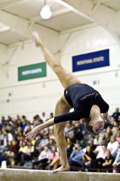 Kalliah McCartney performs a front aerial during her beam routine during a meet inside The Nest.