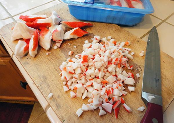 Cut the crab meat or imitation crab meat into small cubes before adding it to the mixing bowl.

