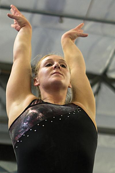 Cayla Beutler poses after a practice session at the Elk Grove location of Byers Gymnastics Center on March 20. At 5 feet 7 inches tall, which is not typical of a gymnast, Beutler is one of the tallest members of the team.
