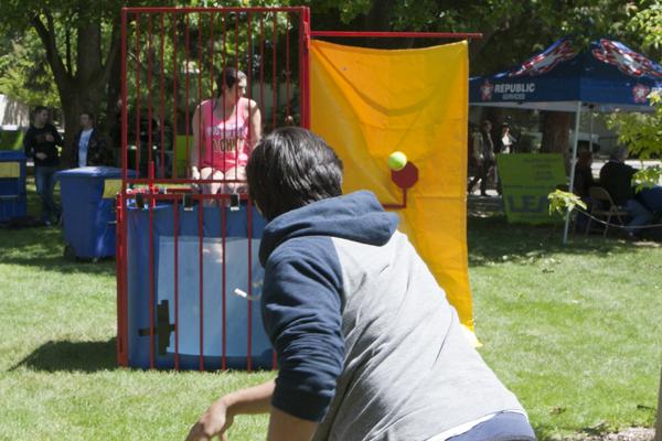 Alpha Chi Omega President Katie Dillen waits to be dunked as sophomore civil engineer Jason Estrella makes a throw on Wednesday for the Earth Day events in the Library Quad.
