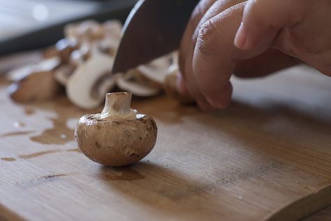 To build an epic hangover buger, you need to chop and prepare the condiments. Some options include mushrooms, tomatoes, guacamole and of coarse, bacon.