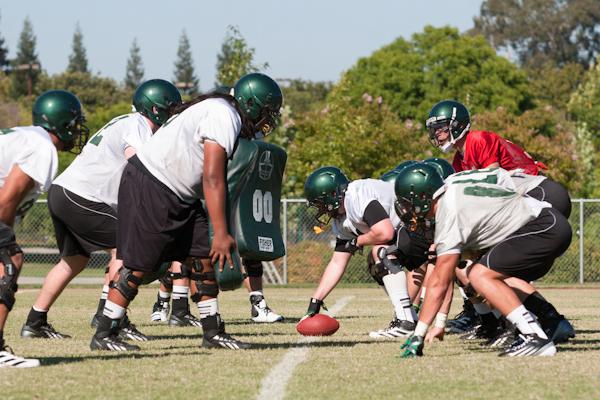 Hornet junior quarterback, No. 12, Garrett Safron works with the offensive line on Sunday at Hornet Stadium during the first practice of the 2013 season.