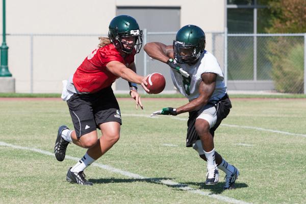 Hornet freshmen quarterback, No. 18, Nolan Sorensen hands off to senior runningback, No. 8, Ezekiel Graham during Sunday's practice at Hornet Stadium.