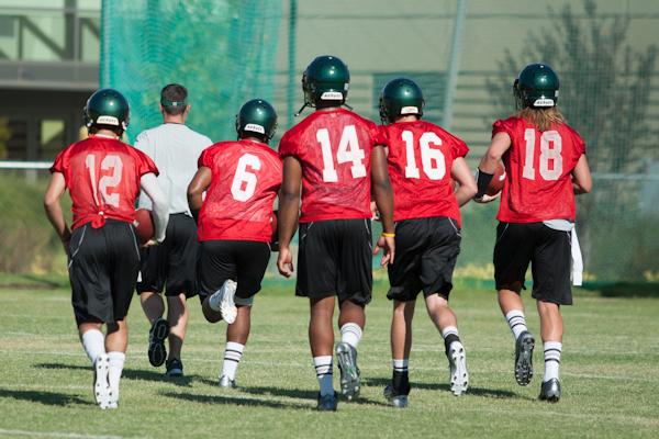 Hornet quarterbacks junior No. 12 Garrett Safron, freshman No. 6 Jihad Vercher, sophomore No. 14 Marcus McDade, freshman No. 16 Daniel Kniffin and freshman No. 18 Nolan Sorensen jog off the field at practice on Sunday at Hornet Stadium.