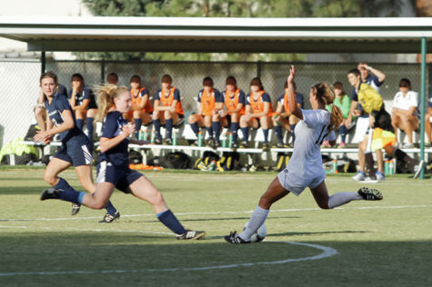 Sac State defender junior No. 12 Kassi Anast attempts to kick the ball passed her NAU opponent at the Oct. 11 game at Hornet Field.