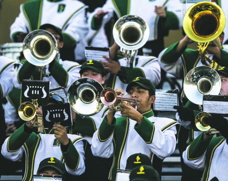 Marching band trumpet player Yotzin Castrejon performs along with the band at Hornet Stadium during Homecoming against Northern Colorado on Saturday. 