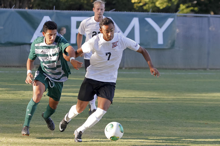 Junior midfielder No.13 Andres Garcia works to steal the ball from Cal State Northridge senior forward No.7 Beto Velasquez in the Oct. 4 game at Hornet Field.