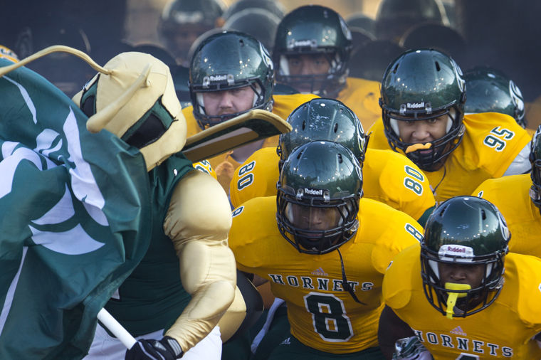The Hornet football team makes their entrance onto the field at the Causeway Classic on Saturday at Hornet Stadium.