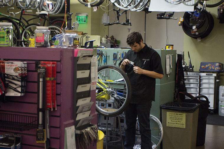 Alex Hegarty, a Peak Adventures mechanic, prepares a bicycle for his bike maintenance class on Nov. 7.