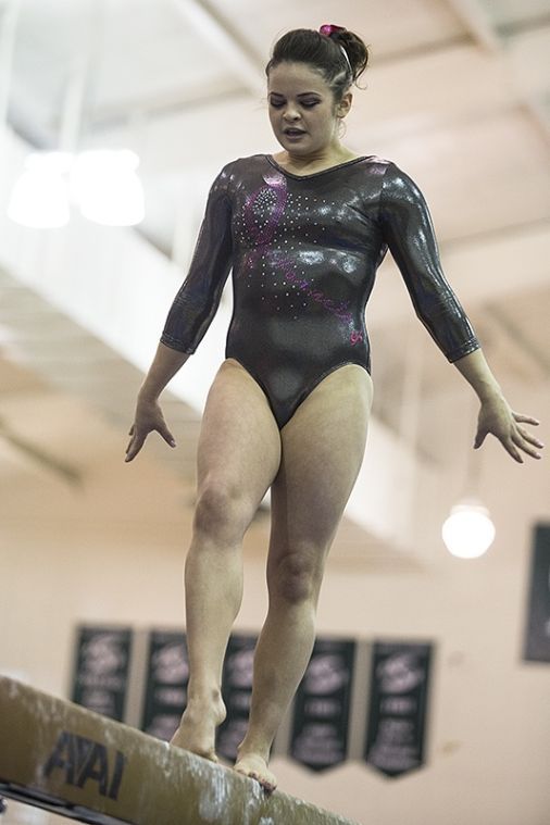 Senior Kailey Hansen sets up for her beam dismount Friday against Cal and San Jose State in The Nest. 
