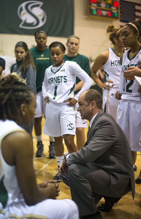 Womens+basketball+head+coach+Bunky+Harkleroad+talks+to+the+team+during+a+game+inside+The+Nest.