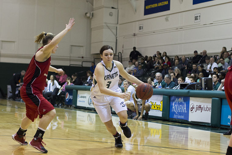 Freshman guard Gigi Hascheff dribbles past the defender. 