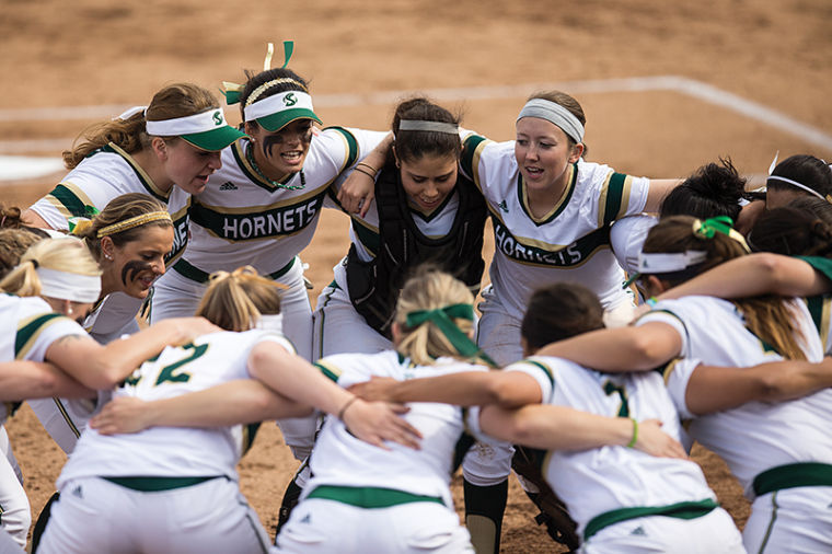 The Hornets pump themselves up during their huddle before the Tuesday game against U.C. Davis. The Hornets won 5-0. 