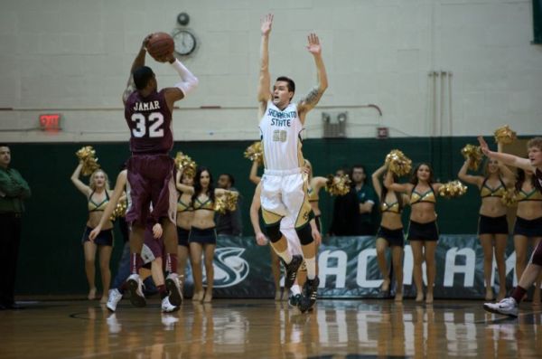 Junior forward Zach Mills goes up to block Montanas Kareem Jamars jump shot in the 70-55 loss to the Grizzlies. 