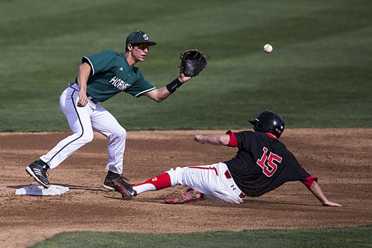 Brandon Hunley tags out University of Utah’s Cory Hunt at second base.