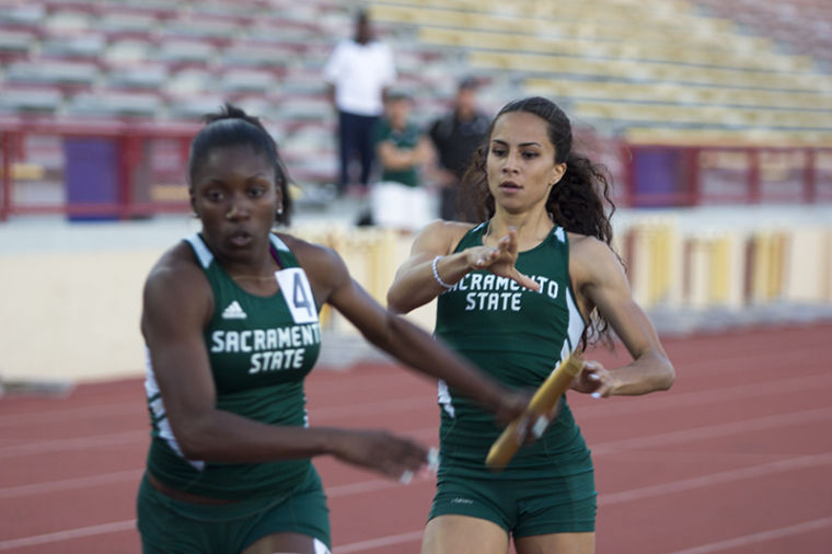 Dominique Whittington takes off after receiving the baton from Megan Pope during the Causeway Classic .