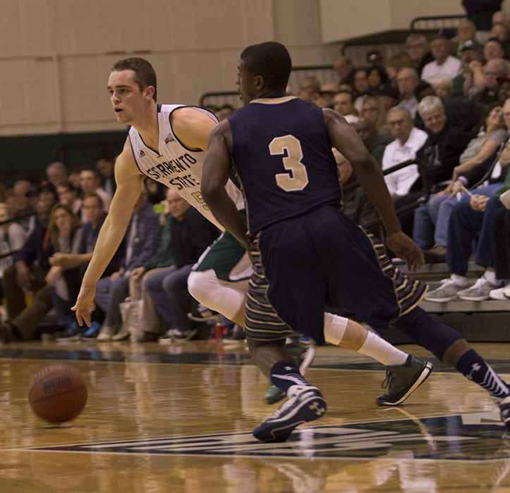 Senior guard Dylan Garrity of Sacramento State cuts past Montana State guard Michael Dison as he looks for an open teammate to make a pass to during a men's basketball game in the Hornets' Nest on Thursday Jan. 29, 2015. Garrity broke Sac State’s all time record of career assists, ending the game with a new record of 504.