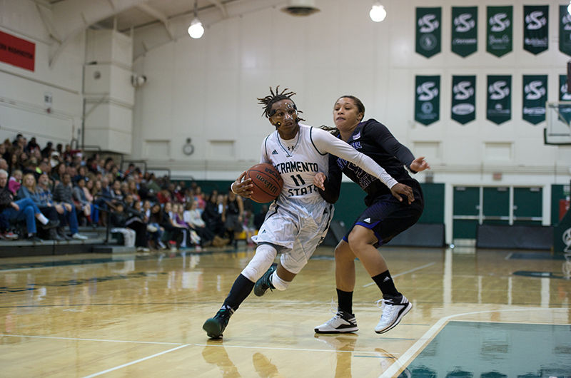 Senior guard, Takara Burse powers past Weber State guard Brianna Averette at the Hornets’ Nest on Saturday Jan. 24, 2015. The Hornets trampled Weber State 108-65.