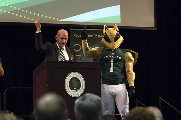 President Robert Nelson raises his pinky as he calls out stingers up during his first Fall Address in the University Union ballroom on Thursday, August 27, 2015.