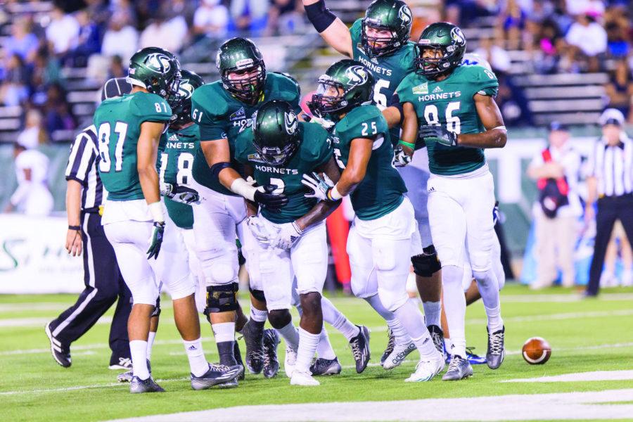 Wide reciever DeAndre Carter celebrates with his teammates after scoring a touchdown in a game against Menlo on Saturday, Sept. 20, 2014. The Hornets went on to win the game 59-14.