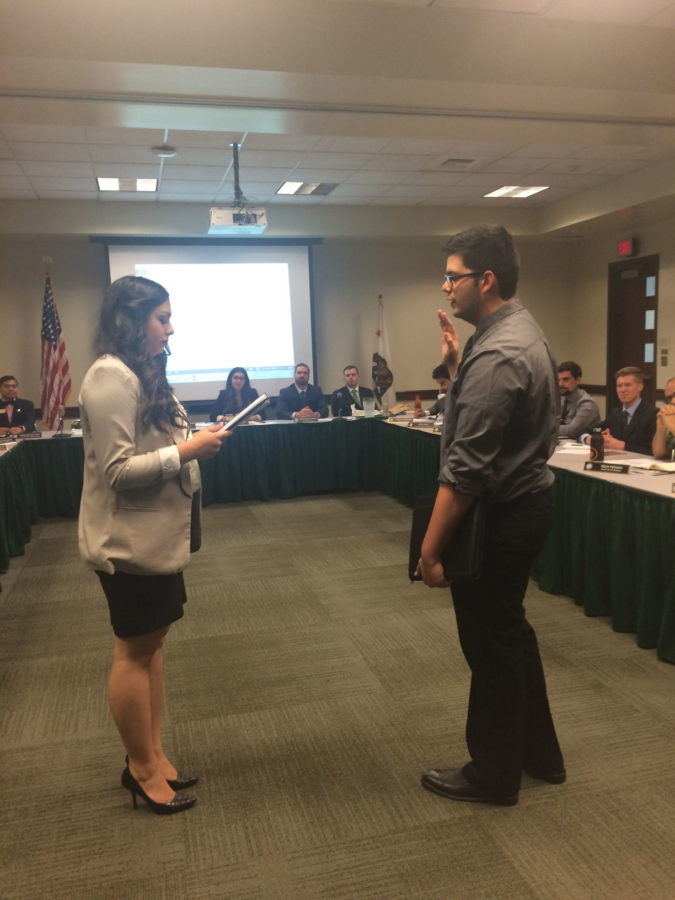 Melissa Bardo, ASI President, swears Abraham Mendoza III to the office of Director of Health and Human Services at the September 2 working board meeting in the Orchard Suite of the University Union.