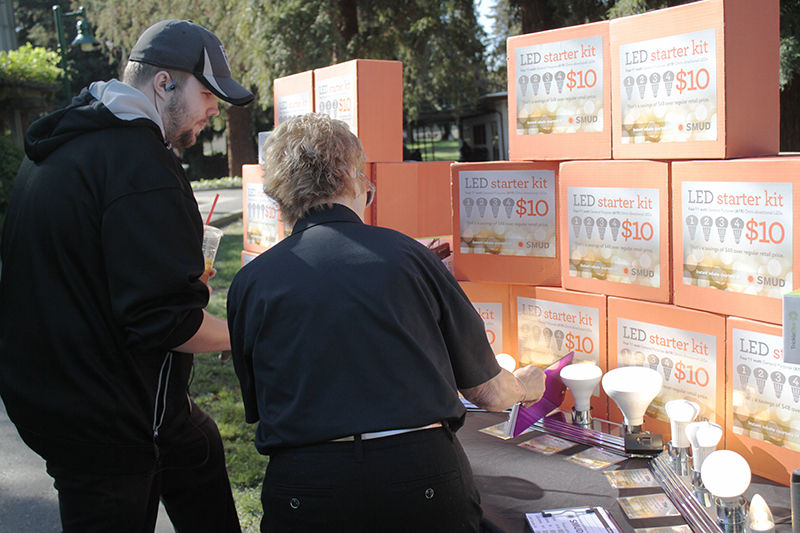 Carol Stout from SMUD (right) shows James Presley (left) SMUD’s LED starter kit during Energy Conservation Day on Thursday, Oct. 9, 2015 at the library quad.