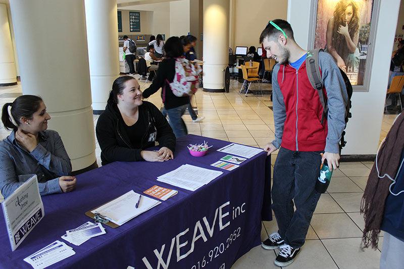 (Left to right) Sacramento State students Melissa Daciuk and Brenna Haller inform Zion Lewis about the clothing drive on Thursday, Nov. 5, 2015 in the Union.