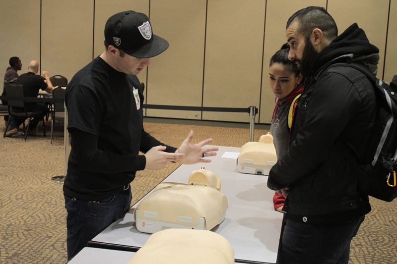 From left, Chris Elton, Ali Abrishami, and Mona Villamayor, during the Sacramento State, Hornet Heartsaver Event, Tuesday, Febuary 2, 2016. Elton shows, Abrishami and Villamayor the prober hand placement when attempting CPR.
