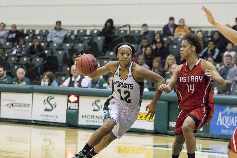 Ashlyn Crenshaw drives the lane against Bianca Littleton of Cal State East Bay on Sunday, Nov. 8, 2015 at the Hornets Nest. Crenshaw led the Hornets offensively with 21 points.