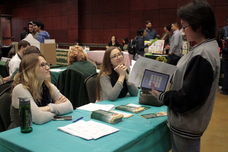 Samantha Lindsay, Clair Just and Tina Payanouvong discuss majors during the ASI Major Fair in the Univesity Union Redroom, Monday, March 8, 2015.