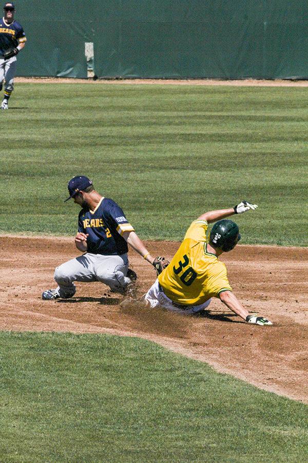 Sophomore Andrew McWilliam steals second base at John Smith Field, April 3. The Hornets defeated the Bears 6-3.