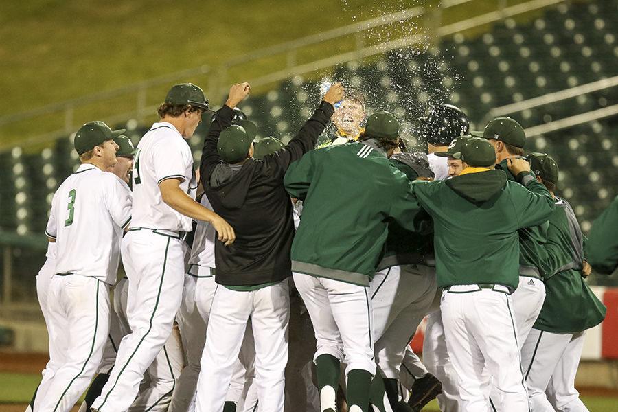 The Sacramento State baseball team rushes Gunner Pollman after hitting a walk off hit against Fresno State at Raley Field, Wednesday, April 27.