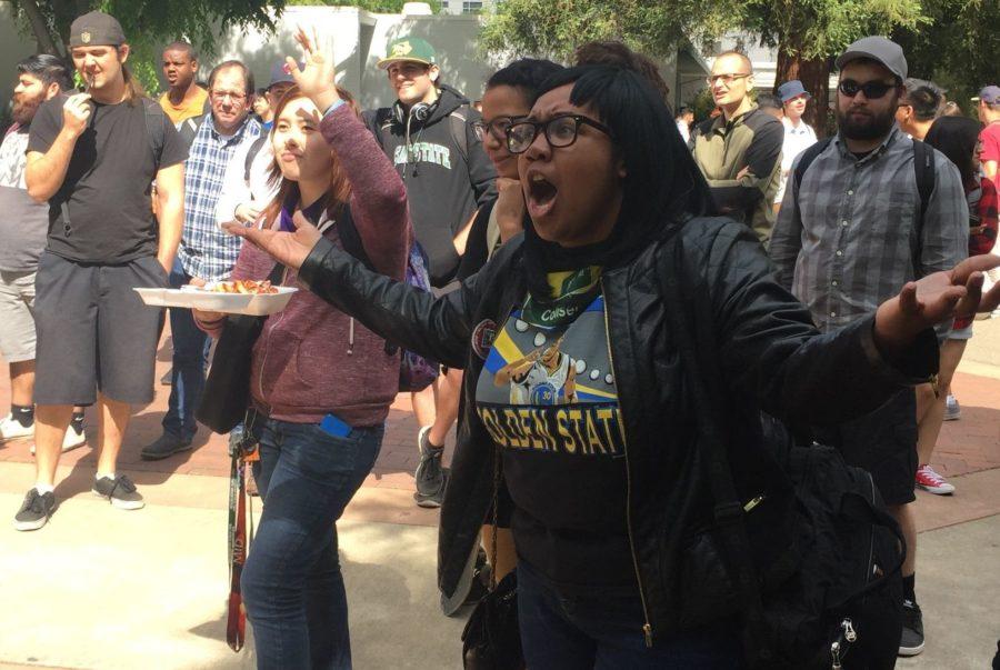 Students at Sacramento State react to a preacher and his interpretation of the Bible on Thursday, April 14. The debate between crowd and preacher lasted for several hours.