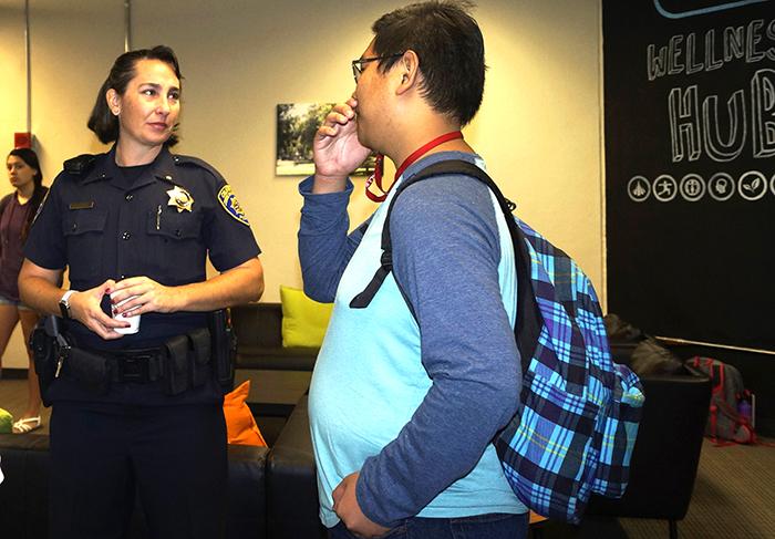 Campus police Lt. Christina Lofthouse chats with a Sac State student at the Coffee With The Cops event at the Wellness Hub on Sept. 14. (Photo by Marivel Guzman)
