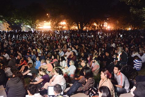 Spectators sit on the lawn outside the University Union to watch a live stream of the Cornel West speech on Thursday, Sept. 29. (Photo by Matthew Dyer)