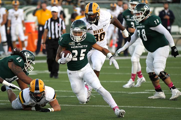 Running back Jordan Robinson sprints past Northern Colorado University defenders on Saturday, Oct. 3, 2015 at Hornet Stadium. Robinson lead the team in rushing with 149 yards on 28 carries. (Photo by Francisco Medina)